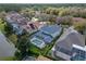 Aerial view showcasing the backyard pool, landscaping, and nearby pond at 10220 Deercliff Dr, Tampa, FL 33647
