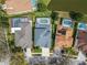 Aerial view of homes with screened-in pools and well-maintained yards in a residential neighborhood at 10220 Deercliff Dr, Tampa, FL 33647