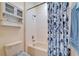 Clean full bath with shower and tub with cabinet storage for bath supplies at 10220 Deercliff Dr, Tampa, FL 33647