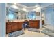 Well-lit bathroom features dual sinks, dark wood cabinets, and large mirrors at 10220 Deercliff Dr, Tampa, FL 33647