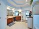 Bright bathroom boasts dual sinks, wood cabinets, and tiled floor at 10220 Deercliff Dr, Tampa, FL 33647