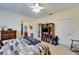 Spacious bedroom with ceiling fan, featuring a ceiling fan and multiple entry doors at 10220 Deercliff Dr, Tampa, FL 33647