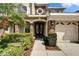 Welcoming home entrance with stone accents, double front doors, and neatly trimmed landscaping at 10220 Deercliff Dr, Tampa, FL 33647