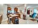 Bright kitchen featuring wood cabinets, island with seating, stainless steel refrigerator and open floor plan at 10220 Deercliff Dr, Tampa, FL 33647