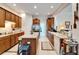 Bright kitchen with wood cabinets, island, stainless fridge, tile floor, and open layout at 10220 Deercliff Dr, Tampa, FL 33647