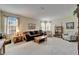 Bright living room with windows, a brown sofa, and carpeted floors at 10220 Deercliff Dr, Tampa, FL 33647