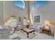Bright, airy living room with soaring ceilings, large windows, and classic floral furnishings at 10220 Deercliff Dr, Tampa, FL 33647