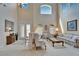 Elegant living room featuring high ceilings, abundant natural light, and traditional furnishings at 10220 Deercliff Dr, Tampa, FL 33647