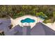 Aerial view of the community pool, seating, and clubhouse at 10220 Deercliff Dr, Tampa, FL 33647
