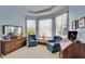 Bright sitting area offers bay window, comfortable chairs and wood furniture at 10220 Deercliff Dr, Tampa, FL 33647