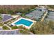Community pool and tennis courts in an aerial view at 10220 Deercliff Dr, Tampa, FL 33647