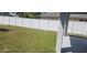 Spacious backyard enclosed with a white fence, providing an ideal setting for outdoor activities and relaxation at 105 2Nd Ne Ave, Lutz, FL 33549