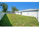 Large, fenced backyard featuring green grass and mature trees at 105 2Nd Ne Ave, Lutz, FL 33549