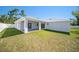 Large backyard with privacy fence, patio and green grass at 105 2Nd Ne Ave, Lutz, FL 33549