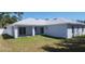 Spacious backyard with a covered patio, manicured lawn, and freshly painted exterior at 105 2Nd Ne Ave, Lutz, FL 33549