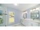 Modern bathroom featuring double vanity, tile floors, and a glass-enclosed shower at 105 2Nd Ne Ave, Lutz, FL 33549