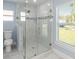 Bathroom featuring glass shower, toilet, and window, with tile floors at 105 2Nd Ne Ave, Lutz, FL 33549