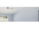 Bedroom featuring a ceiling fan, light blue walls, and a window at 105 2Nd Ne Ave, Lutz, FL 33549