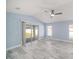 Spacious bedroom featuring tile flooring, a ceiling fan, and sliding glass doors to the backyard at 105 2Nd Ne Ave, Lutz, FL 33549