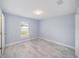 Bedroom features tile flooring, window, and neutral paint at 105 2Nd Ne Ave, Lutz, FL 33549