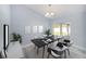 Open dining room with modern black table, natural light and access to the outdoor living area at 105 2Nd Ne Ave, Lutz, FL 33549