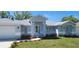 Beautiful single-story home showcasing manicured lawn and charming front entrance at 105 2Nd Ne Ave, Lutz, FL 33549