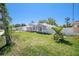 Charming single-story home featuring a well-manicured lawn, modern architecture, and a white fence at 105 2Nd Ne Ave, Lutz, FL 33549