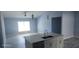 Open-concept kitchen with a stylish island, modern appliances, and ample space for entertaining and culinary creativity at 105 2Nd Ne Ave, Lutz, FL 33549