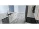 Bright kitchen featuring stainless steel appliances, a modern faucet, white cabinets, and a tile floor at 105 2Nd Ne Ave, Lutz, FL 33549