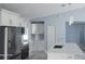 Bright kitchen featuring stainless steel appliances, white cabinets, and a large center island with a sink at 105 2Nd Ne Ave, Lutz, FL 33549