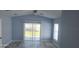 Bright living room featuring vaulted ceilings, and sliding glass doors leading to the backyard at 105 2Nd Ne Ave, Lutz, FL 33549