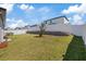 Picturesque backyard features lush lawn, white vinyl fence, and small tree at 1050 Davis Heather Cir, Seffner, FL 33584