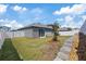 Relaxing backyard features lush green lawn, white vinyl fencing, and sliding glass doors at 1050 Davis Heather Cir, Seffner, FL 33584