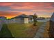 Evening view of landscaped backyard with vinyl fencing and patio perfect for entertaining guests at 1050 Davis Heather Cir, Seffner, FL 33584