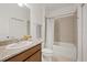 Bathroom featuring granite vanity, tub with tile surround, and white shower curtain at 1050 Davis Heather Cir, Seffner, FL 33584