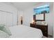 Bright bedroom features white walls, a TV, and a dark wood dresser at 1050 Davis Heather Cir, Seffner, FL 33584