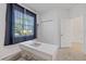 Bright bedroom with a large window, a closet, and a clean, minimalist design at 1050 Davis Heather Cir, Seffner, FL 33584