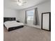 Simple bedroom features carpet floors, large windows, and black furniture at 1050 Davis Heather Cir, Seffner, FL 33584