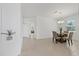 Bright dining room featuring tile floors and a modern chandelier above a glass table at 1050 Davis Heather Cir, Seffner, FL 33584