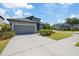 Charming home featuring a two-car garage, well-manicured lawn, and lush landscaping at 1050 Davis Heather Cir, Seffner, FL 33584