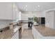 Bright, modern kitchen with stainless steel appliances, granite countertops, and white cabinetry at 1050 Davis Heather Cir, Seffner, FL 33584