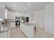 An open-concept kitchen features stainless appliances and a granite island with seating at 1050 Davis Heather Cir, Seffner, FL 33584