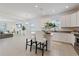 Open-concept kitchen with an island, granite countertops, and white cabinets at 1050 Davis Heather Cir, Seffner, FL 33584
