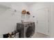 A well-equipped laundry room offers modern washer and dryer units and shelving at 1050 Davis Heather Cir, Seffner, FL 33584