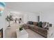 Open concept living room flows into kitchen, featuring a large sectional at 1050 Davis Heather Cir, Seffner, FL 33584