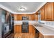 Well-lit kitchen with wood cabinets and stainless steel appliances at 10709 Airview Dr, Tampa, FL 33625