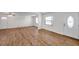 Bright living room with wood-look floors, white walls, and ceiling fan at 10709 Airview Dr, Tampa, FL 33625