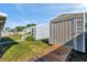 Two storage sheds sit in a lush, green backyard under a bright, blue sky at 10709 Airview Dr, Tampa, FL 33625