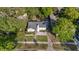 Aerial view of a quaint single-Gathering home with a well-kept lawn and mature trees at 108 S Lincoln Ave, Tampa, FL 33609