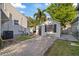 View of backyard with brick pavers and a storage shed, with tropical foliage in the background on a sunny day at 108 S Lincoln Ave, Tampa, FL 33609